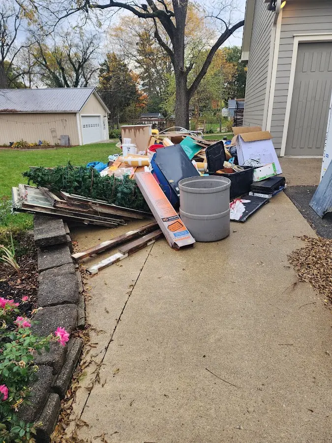 Dumpster being loaded with debris for Residential Dumpster Rental in Pecan Plantation